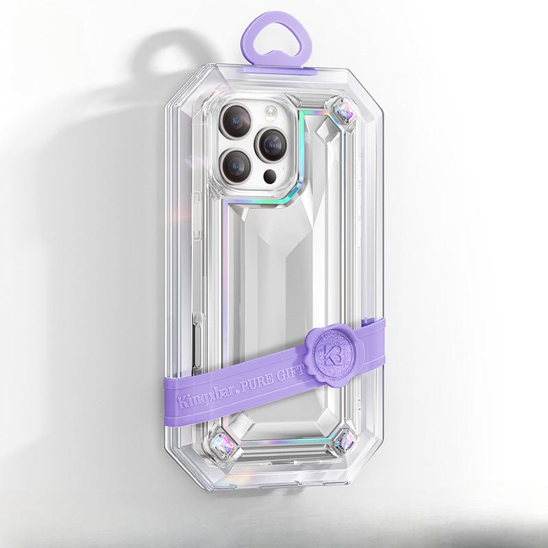 A clear iPhone 16 Pro Max Shockproof 360° Anti-Fall Protective Cover with a jewel-shaped design, purple strap, and decorative seal is shown on a light background, offering comprehensive protection and featuring anti-yellowing material.