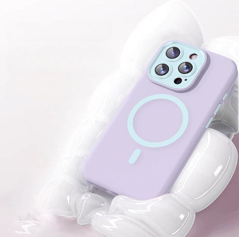 A smartphone with a lavender-colored, Soft TPU Liquid Silicone MagSafe Protective Cover featuring Nano Cushion Technology and a circular design on the back rests on a glossy white surface. The iPhone 16 Pro Max case has three visible camera lenses.