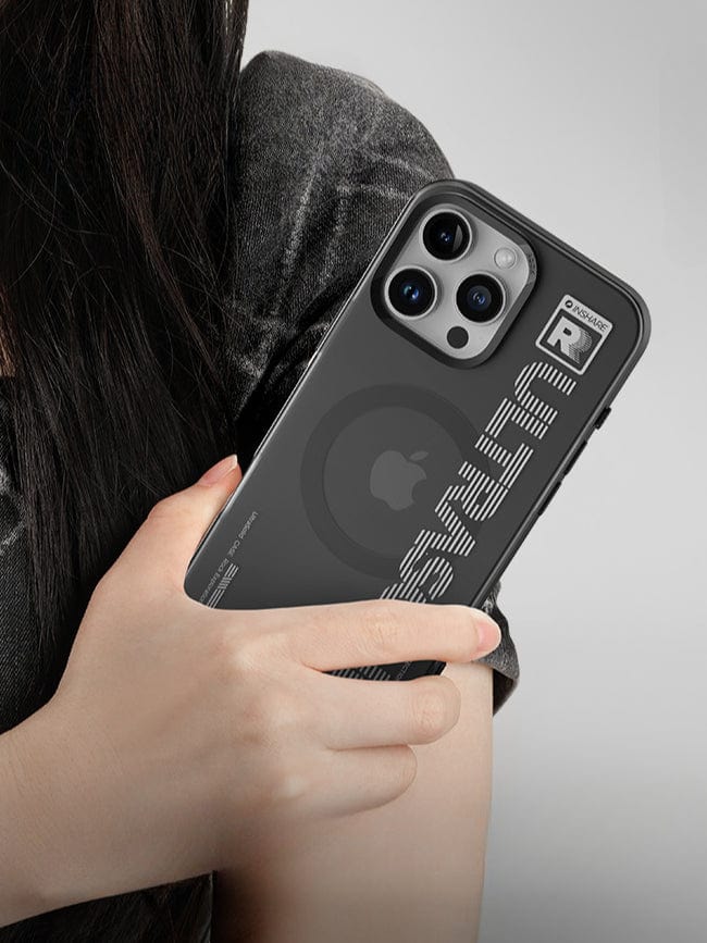 A person holding a black smartphone with a large camera module and an iPhone 16 Pro Max UltraSleek Clear Case featuring a unique design, complete with shockproof 5-layer protection and magnetic wireless charging capabilities.