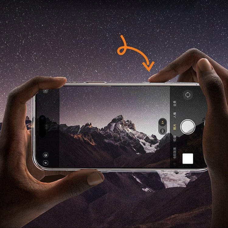 A person is using an iPhone 16 Pro Max, equipped with the Capture Button for iPhone 16 Pro Max Cases – Enhanced Camera Control Attachment, to photograph a starry night sky with mountains. An orange arrow highlights the capture button on the phone display, emphasizing its improved camera control feature.
