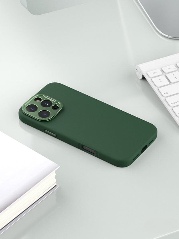 A MagSafe-Compatible iPhone 16 Pro Max Case with Silicone Grip & Aluminum Camera Kickstand sits on a white desk next to a keyboard and a stack of papers.