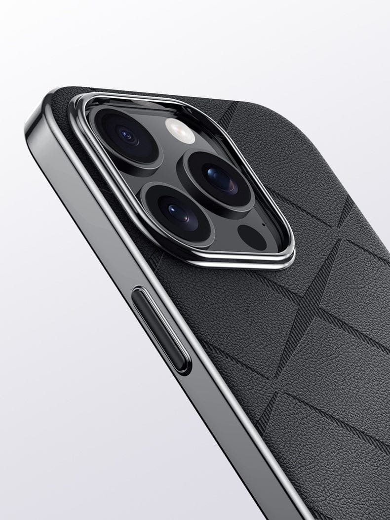 Close-up of a smartphone's rear camera module, featuring three lenses and a flash, with the iPhone 16 Pro Max Premium Leather Case’s shockproof design and durable textured black surface partially visible, complemented by a metal button finish.