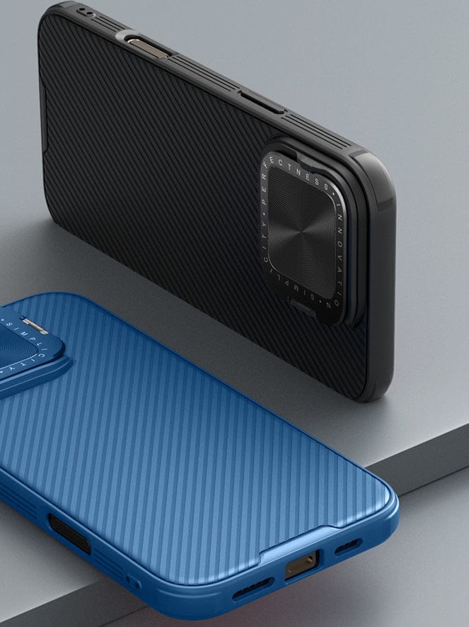 Two smartphones in protective cases, one black and one blue, are placed on a flat surface. The Shockproof Slim Fit iPhone 16 Pro Max case with MagSafe boasts dual-layer protection and an ergonomic anti-slip grip. Both cases have textured designs, and the black case features an adjustable rotating camera cover.