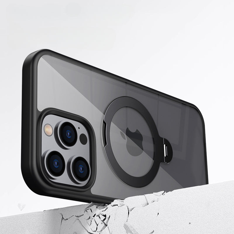 A smartphone with a black protective case featuring a circular magnetic ring stands on a gray surface. The phone has three rear cameras and a flash.