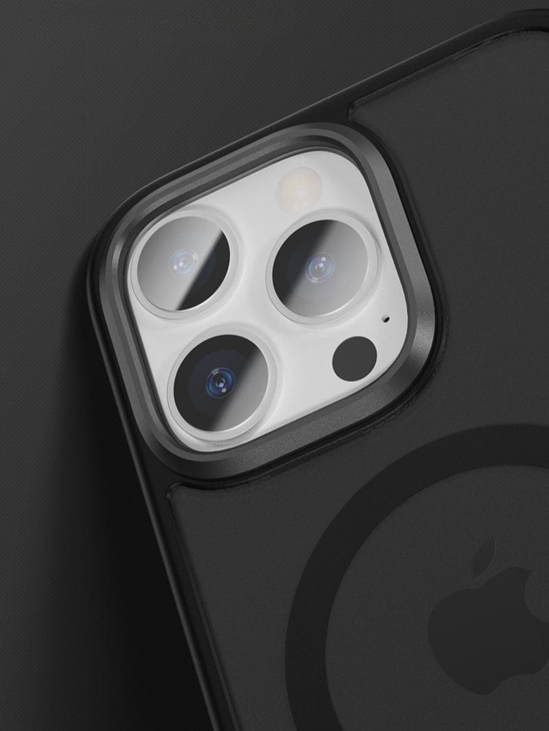 Close-up of a black iPhone 16 Pro Max with three rear camera lenses encased in an aluminum alloy camera frame and an Apple logo, protected by the Golden Shield MagSafe Case that offers anti-fingerprint and shockproof protection.