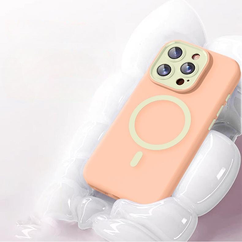 An iPhone 16 Pro Max Case in soft TPU liquid silicone and peach color, featuring Nano Cushion Technology and a circular MagSafe design around the camera module, lies on a white, pillowy surface.