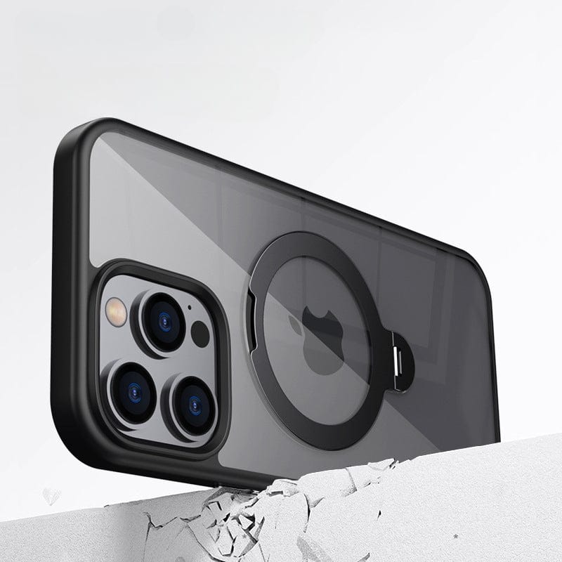 An Ultra-Thin iPhone 16 Pro Max Case with a transparent, black-edged design, featuring a 360° rotating ring stand and MagSafe compatibility, is displayed resting against a textured white background, showcasing the smartphone's three rear cameras.