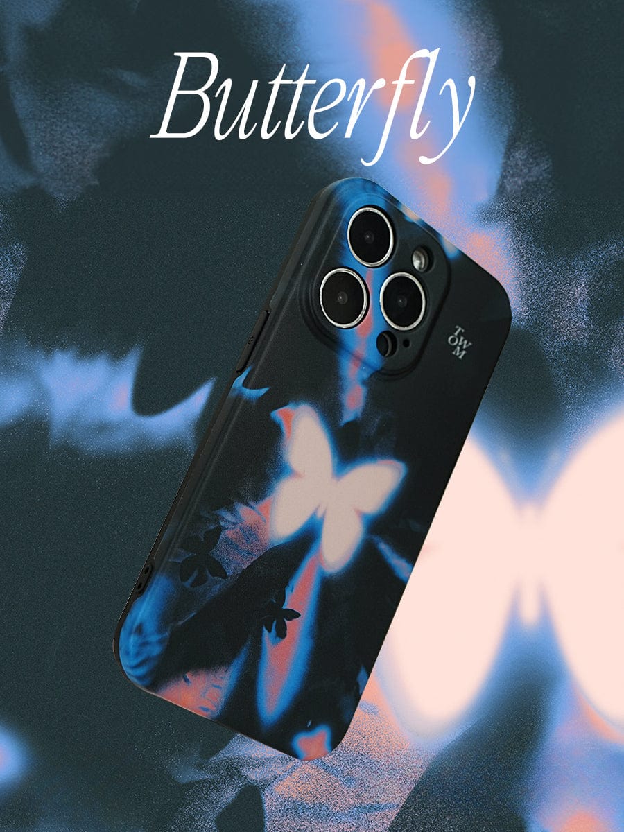 A Luminous Butterfly iPhone 16 Pro Max Case with white and blue butterfly designs is displayed against a matching abstract butterfly-themed background. The word "Butterfly" is written at the top in an elegant white font. The Mystical Glow Design phone case features cutouts for the camera lenses.