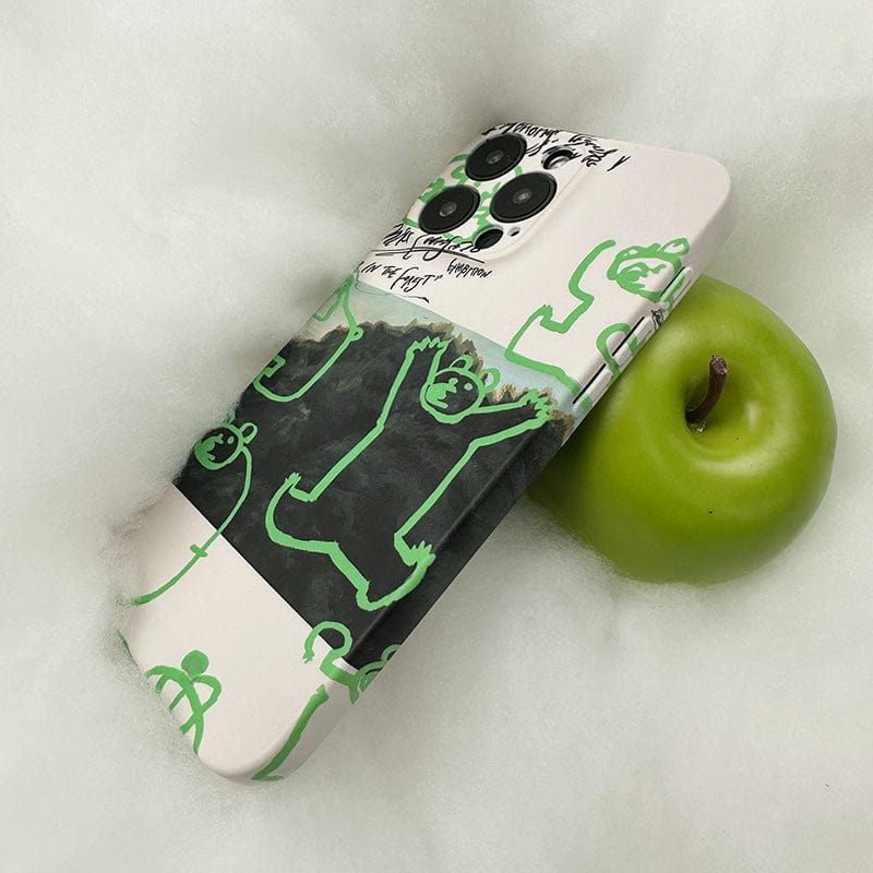 A smartphone, an iPhone 16 Pro Max, adorned with the Unique Green Bear Graphic Case - Creative Forest Art Design, Ultra-Slim with Full-Edge Protection, lies on a fluffy white surface next to a bright green apple.