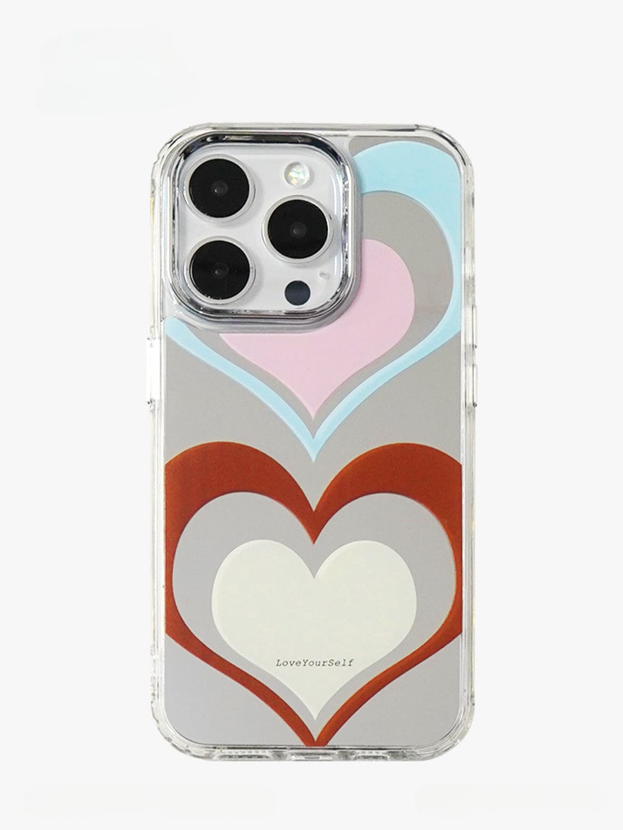 A smartphone in a Retro Heart Layers iPhone 16 Pro Max case, featuring a vibrant "LoveYourSelf" design with layered hearts in shades of red, white, blue, pink, and gray. The text "LoveYourSelf" is prominently visible on the back of the all-inclusive protective cover.