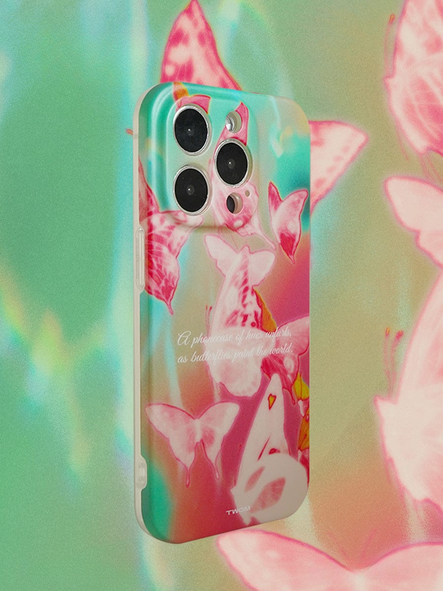 A colorful Butterfly Dreamscape iPhone 16 Pro Max Case featuring pink and white butterflies against a gradient background of teal and peach. The case floats in a matching butterfly-themed backdrop. The text on the case reads, "A flurry of butterflies paint the world.