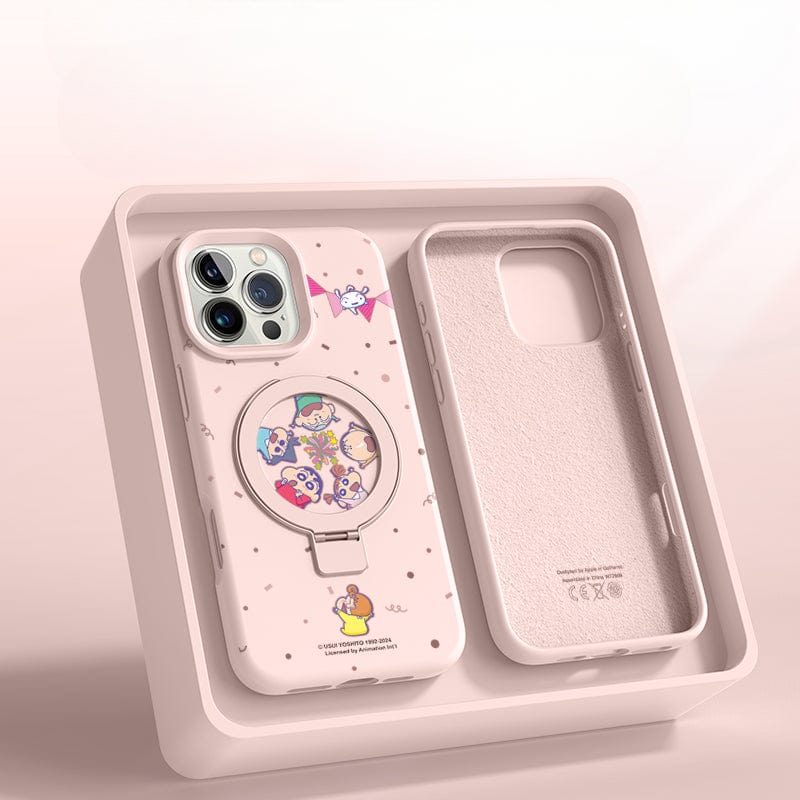 The iPhone 16 Pro Max Cartoon MagSafe Case - Liquid Silicone, featuring a pink color and a circular graphic with various cartoon characters, along with its MagSafe-Compatible Ring Stand, is nestled in a compartmentalized beige box. The colorful character illustrations add a playful touch.