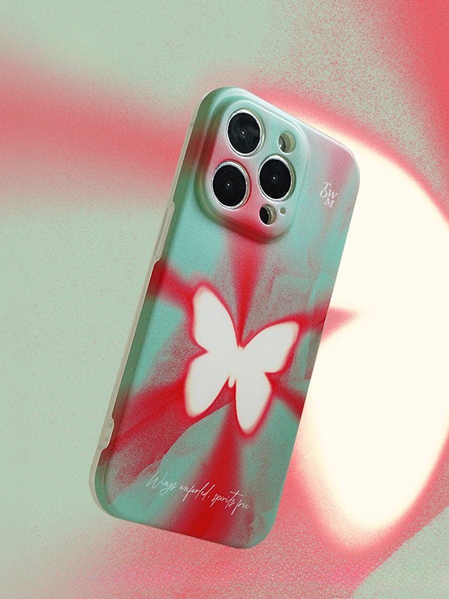 A Butterfly Aura iPhone 16 Pro Max Case, featuring a vivid gradient design with red and green tie-dye patterns and a white butterfly motif, floats gracefully against a matching red and green gradient background.