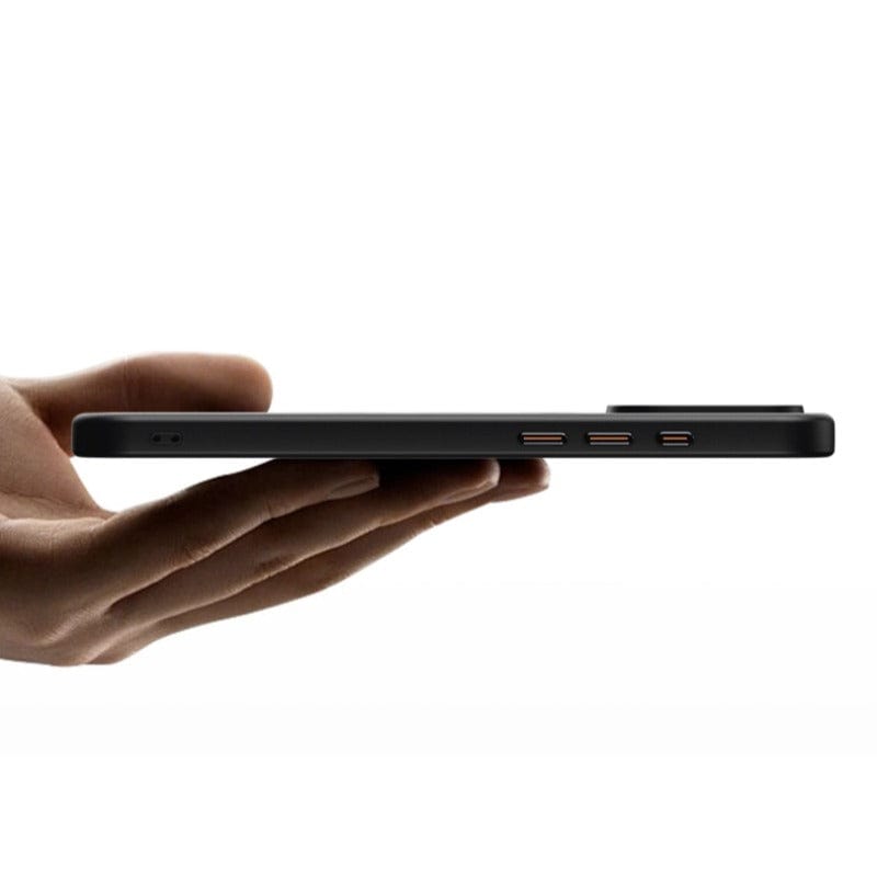 Hand holding an ultra-thin, black tablet with three visible ports on its side, resembling the sleek design of the Ultra-Thin iPhone 16 Pro Max Case with 360° Rotating Ring Stand, MagSafe Compatible, Shockproof Silicone Shell.