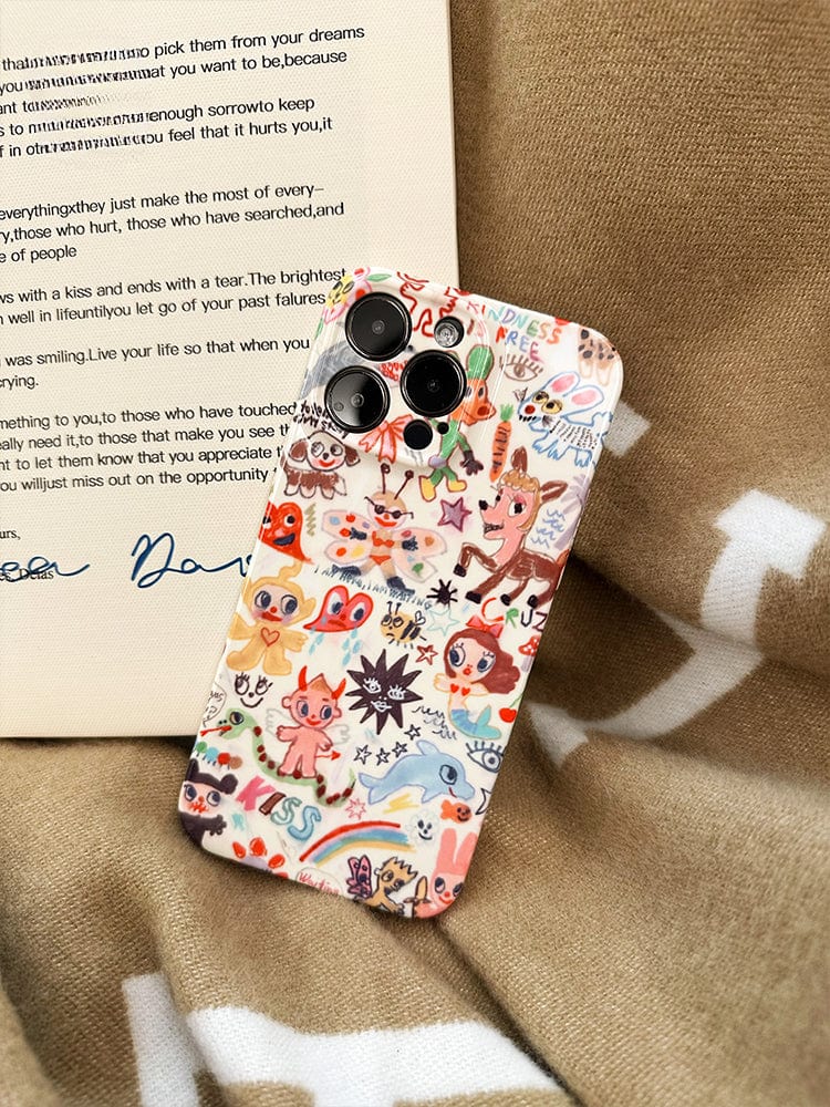 The Whimsical Doodle Art iPhone 16 Pro Max Case is a colorful, cartoon-themed case that features various whimsical characters and positive messages. The design includes animals, flowers, and text like "KISS" and "KINDNESS." Placed on a brown and white patterned fabric, a handwritten note is partially visible next to the phone.