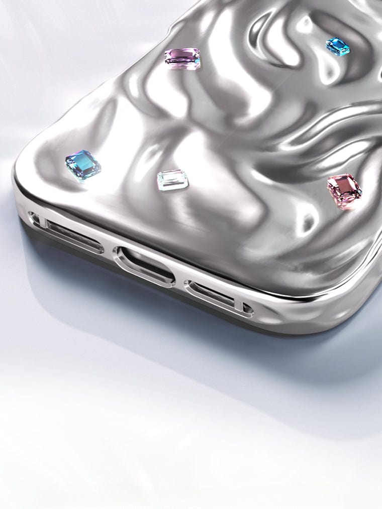 The iPhone 16 Pro Max Luxury Case features a metallic, fluid-like texture with dual-layer protection and a handcrafted gemstone design embedded on its surface.