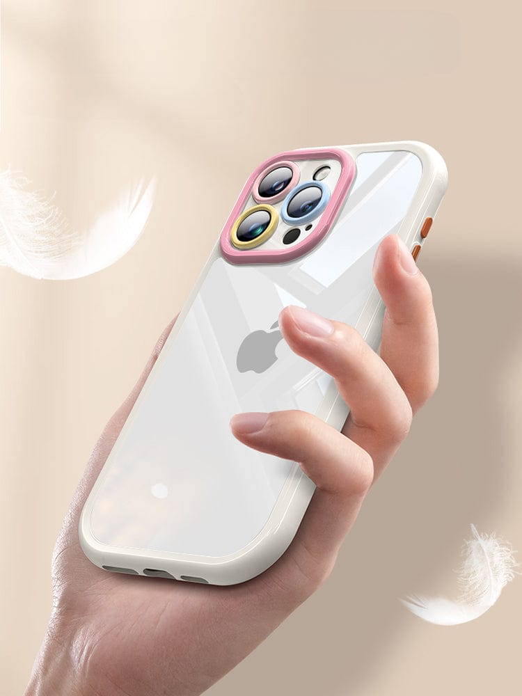 A hand holds the iPhone 16 Pro Max, encased in a Transparent Silicone Protective Cover with a Colorful Camera Ring. The triple camera setup is visible through the clear case, while floating feathers in the background highlight its elegant design and shockproof protection.