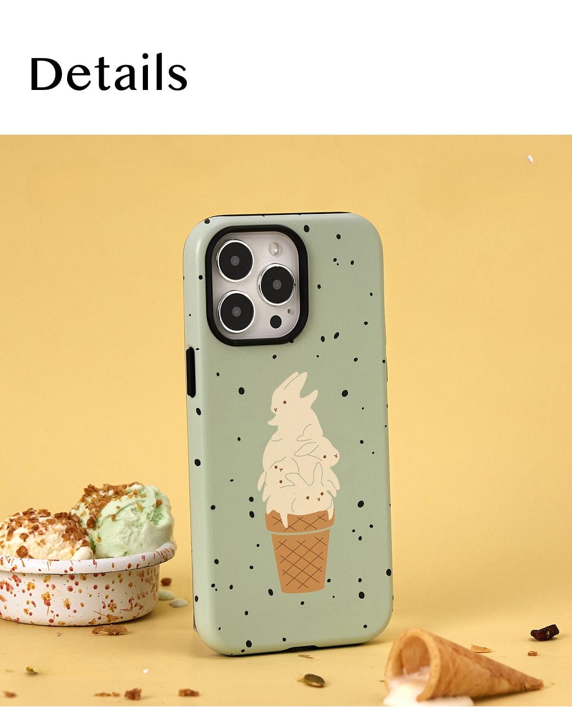 The Mint Ice Cream MagSafe iPhone 16 Pro Max Case, featuring a sweet treat design with black specks and an illustration of an ice cream cone topped with cream, is placed upright against a beige background. Nearby, there is a small bowl of ice cream adorned with sprinkles and a broken ice cream cone. The word "Details" is at the top.