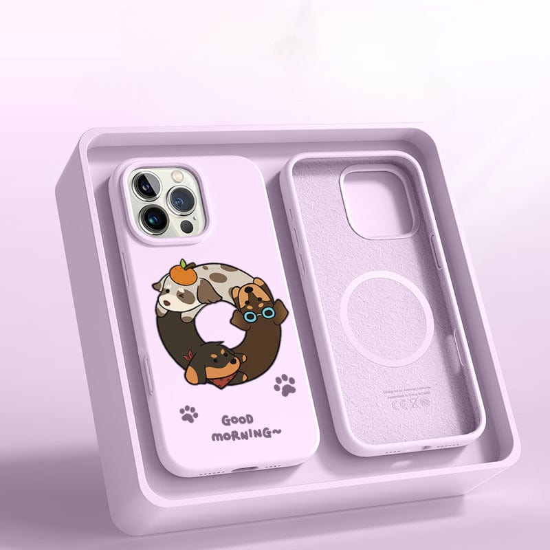 The iPhone 16 Pro Max Case – Good Morning Cartoon Dog Silicone Protective Cover, displayed in a box, features a playful design with adorable cartoon dogs in a relaxing pose and the text "Good Morning." This case also offers triple-layer shockproof protection.