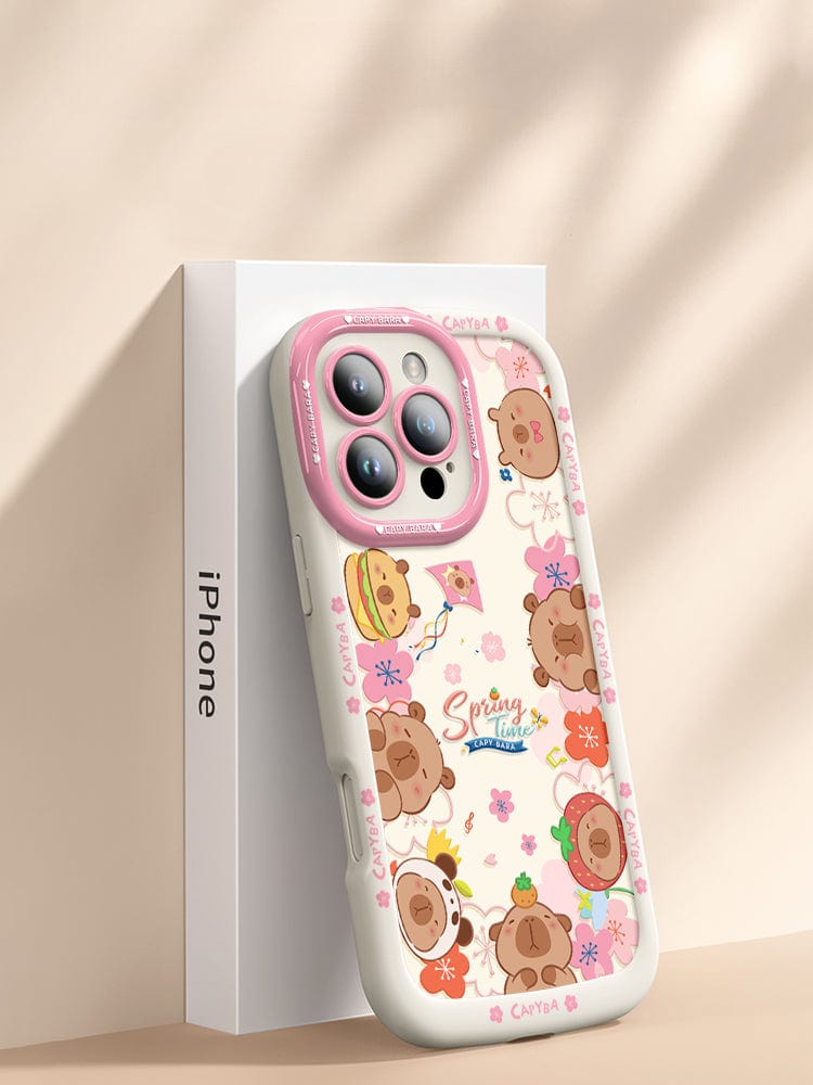 An iPhone 16 Pro Max Cute Bear Silicone Case showcasing playful cartoon bear heads with various accessories. This case features a predominantly dark design accented with floral elements and the "Spring Time" text at its center. It offers not just style but also shockproof protection due to its soft touch liquid silicone construction, ensuring durability and anti-scratch properties.