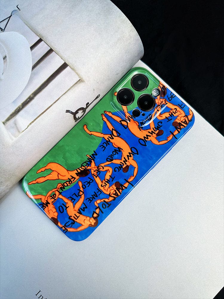 A smartphone with a vibrant *Vibrant Art Dance iPhone 16 Pro Max case - Bold Expression with Colorful Figures* featuring animated imagery and black text rests on an open magazine. The case showcases orange human figures set against a green and blue background, while the magazine's pages display visible text and images.