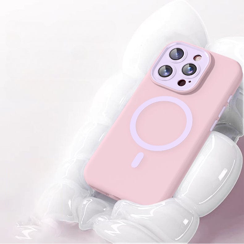 An iPhone 16 Pro Max, adorned with a pink Soft TPU Liquid Silicone MagSafe Protective Cover featuring Nano Cushion Technology and a circular design on the back, rests on a white surface.