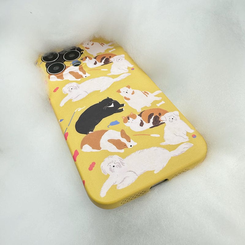 A Playful Pups iPhone 16 Pro Max Case, boasting a cute dog pattern design for full protection, lies on a soft, fluffy white surface.