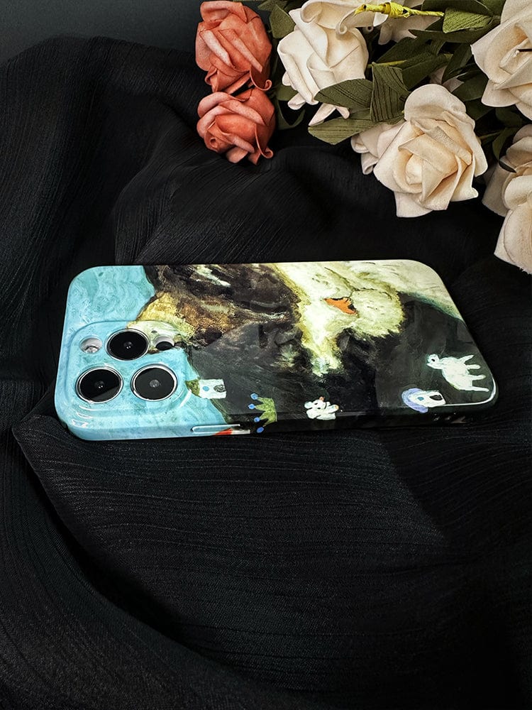 A smartphone with a Whimsical Cat Dream iPhone 16 Pro Max case, showcasing an artistic and playful design of a painted scene featuring a grassy hill with a few animals, lies on a black textured fabric. Next to it, there are roses, some white and some pink, adding a touch of elegance to the composition.