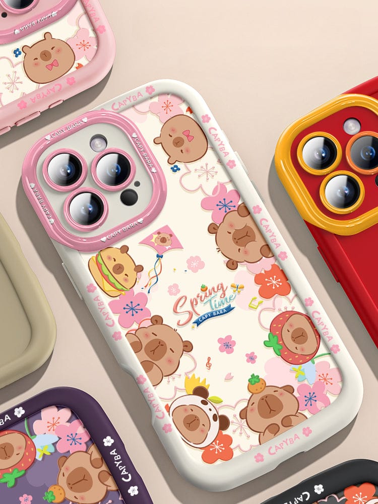 An iPhone 16 Pro Max Cute Bear Silicone Case showcasing playful cartoon bear heads with various accessories. This case features a predominantly dark design accented with floral elements and the "Spring Time" text at its center. It offers not just style but also shockproof protection due to its soft touch liquid silicone construction, ensuring durability and anti-scratch properties.