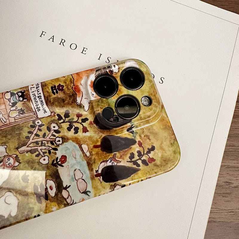 A smartphone with a Charming Forest Friends iPhone 16 Pro Max Case, adorned with whimsical animal village designs, rests on a book or document titled "FAROE ISLANDS." The phone's three camera lenses are clearly visible. The background surface appears to be light-colored wood.