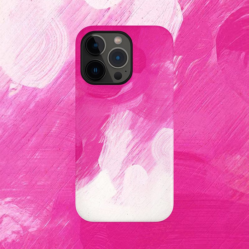 A smartphone, specifically an iPhone 16 Pro Max with the Bold Pink Brushstroke iPhone 16 Pro Max Case, features a striking pink and white abstract design. The background mirrors this same colorful pattern, creating a cohesive look. At the top left corner, the phone's camera lenses are prominently displayed.