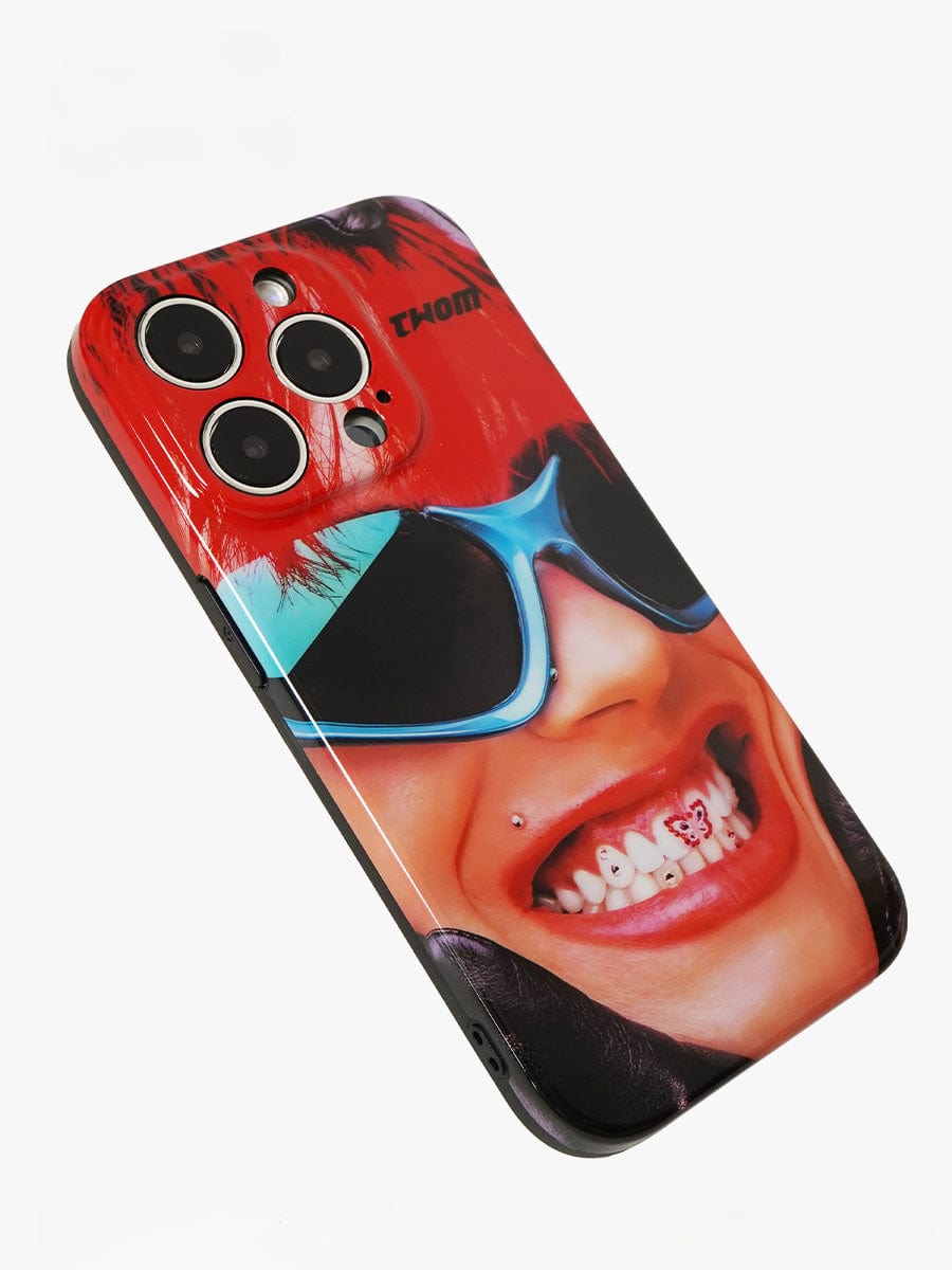 A Bold Rockstar iPhone 16 Pro Max Case featuring a vibrant pop art design of a smiling person with red hair, blue sunglasses, a lip piercing, and visible teeth.