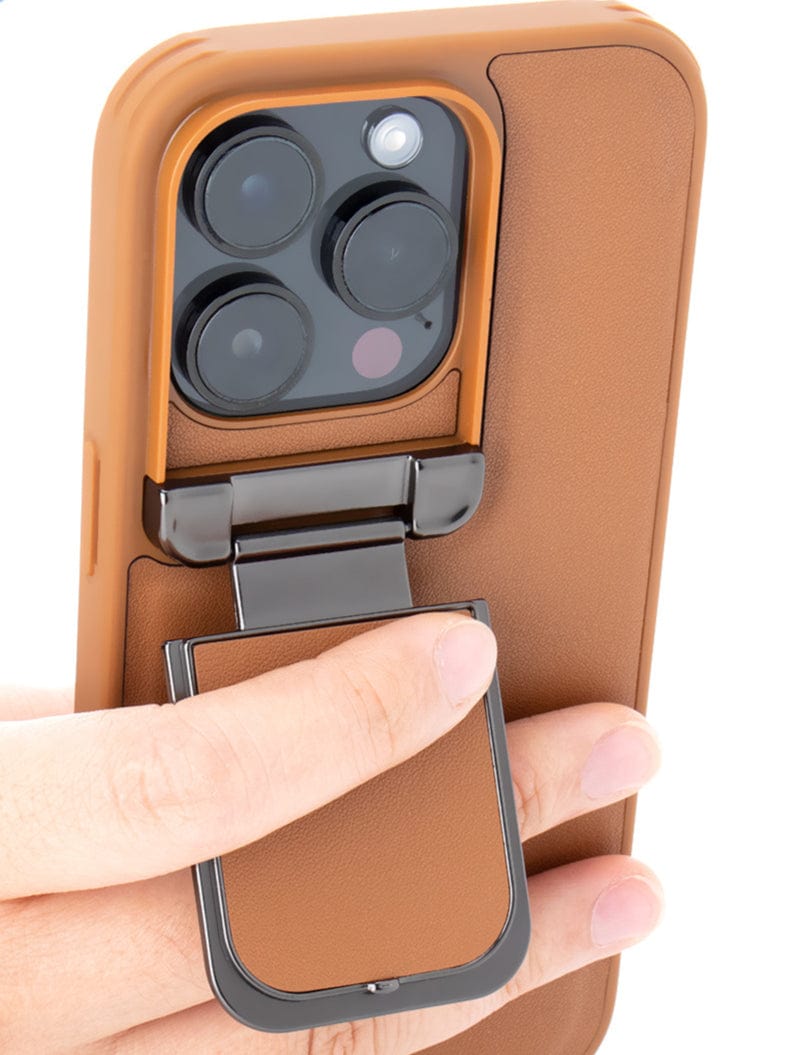 A person holds a premium iPhone 16 Pro Max, encased in a luxurious leather case that features an integrated metallic kickstand, camera shield, and shockproof protective cover.