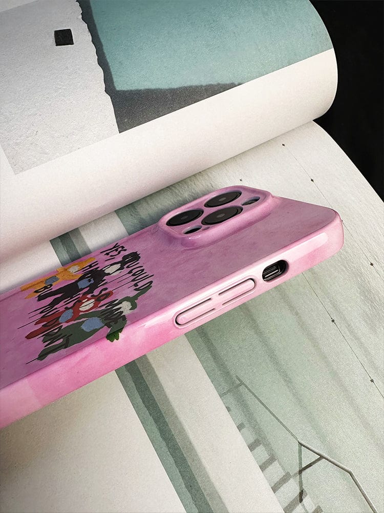 A vibrant purple iPhone 16 Pro Max with a Bold Pink "Playful Critique" case, showcasing a unique artistic statement, stands on an open book displaying abstract or minimalist photography. The phone's camera lenses and charging port are visible. The pages have muted tones of green and white.