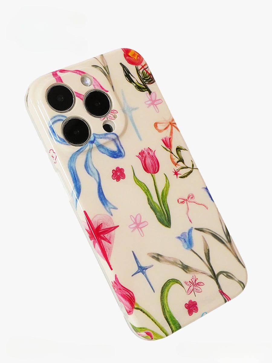 The Floral Dreams iPhone 16 Pro Max Case features an elegant all-inclusive protective cover with colorful botanical designs, including illustrations of flowers, ribbons, and stars. Additionally, it has precise cutouts for the camera lenses.