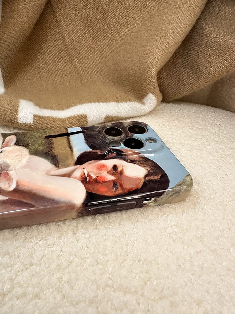 A Pastoral Art iPhone 16 Pro Max Case, showcasing a vintage-inspired artwork of a woman with a modern twist, resting on a soft, beige fabric surface.