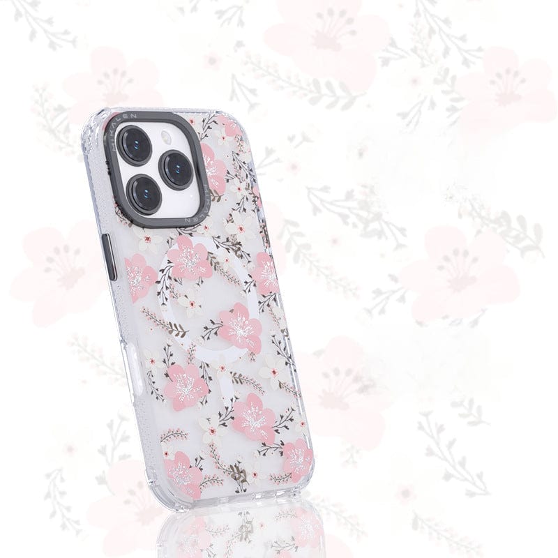 Introducing the Floral MagSafe iPhone 16 Pro Max Case: a shockproof clear cover that features an elegant 3D flower design with pink flowers and green leaves. The background exhibits an enlarged, faded version of the same floral pattern, ensuring both style and seamless charging compatibility with its TPU + PC protective shell.