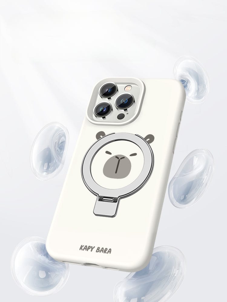 A smartphone encased in the iPhone 16 Pro Max Capybara Case - featuring a MagSafe stand, liquid silicone material, and a shockproof protective cover - is surrounded by floating, transparent bubbles against a white, minimalistic background.