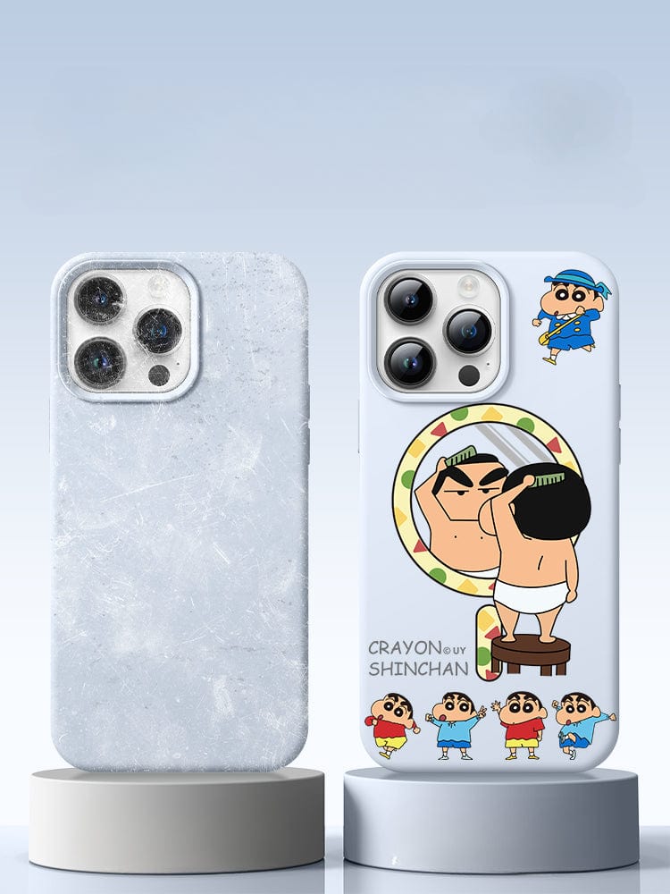 Two smartphone cases are on display. The left case, made of premium liquid silicone material, has a plain, frosted design. The right case is the iPhone 16 Pro Max Crayon Shinchan Case, featuring a cute cartoon design with multiple Shin-chan illustrations and offers triple-layer shockproof protection for extra durability.