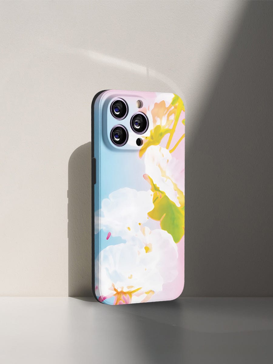 Pastel Bloom iPhone 16 Pro Max Case with a vibrant floral design encases an iPhone 16 Pro Max, showcasing its quadruple camera setup, standing upright against a light gray background.