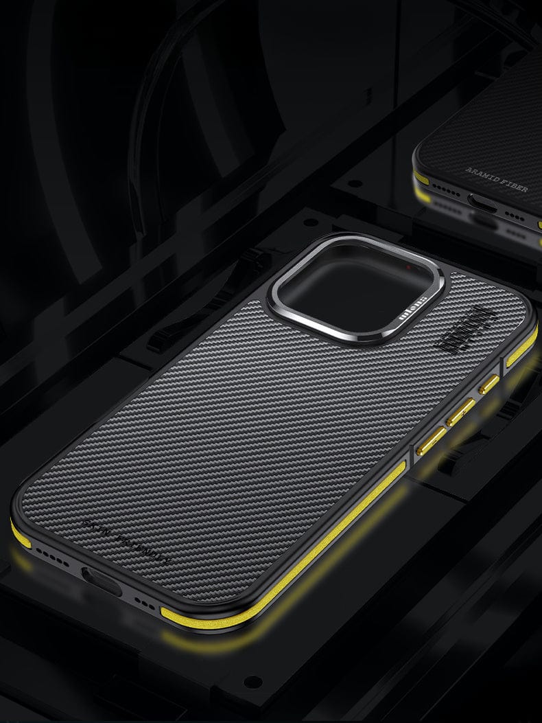 A close-up image of an iPhone 16 Pro Max equipped with the N52 Magnetic MagSafe Case. The smartphone features a textured, metallic 600D aramid fiber cover designed for double layered shock absorption and showcases a prominent camera section highlighted by yellow accents along the sides.