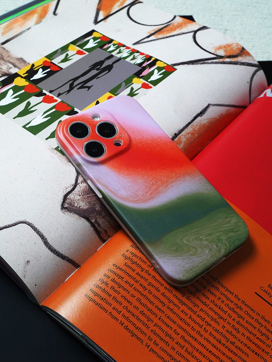 A Sunset Swirl iPhone 16 Pro Max, adorned with an abstract gradient design from its stylish all-inclusive protective cover, rests on an open magazine.