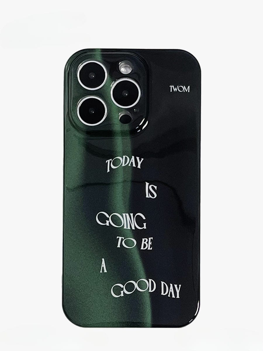 A smartphone featuring the Good Day Quote iPhone 16 Pro Max Case showcases a sleek dark green design, three rear camera lenses, and white text that reads "Today is going to be a good day.