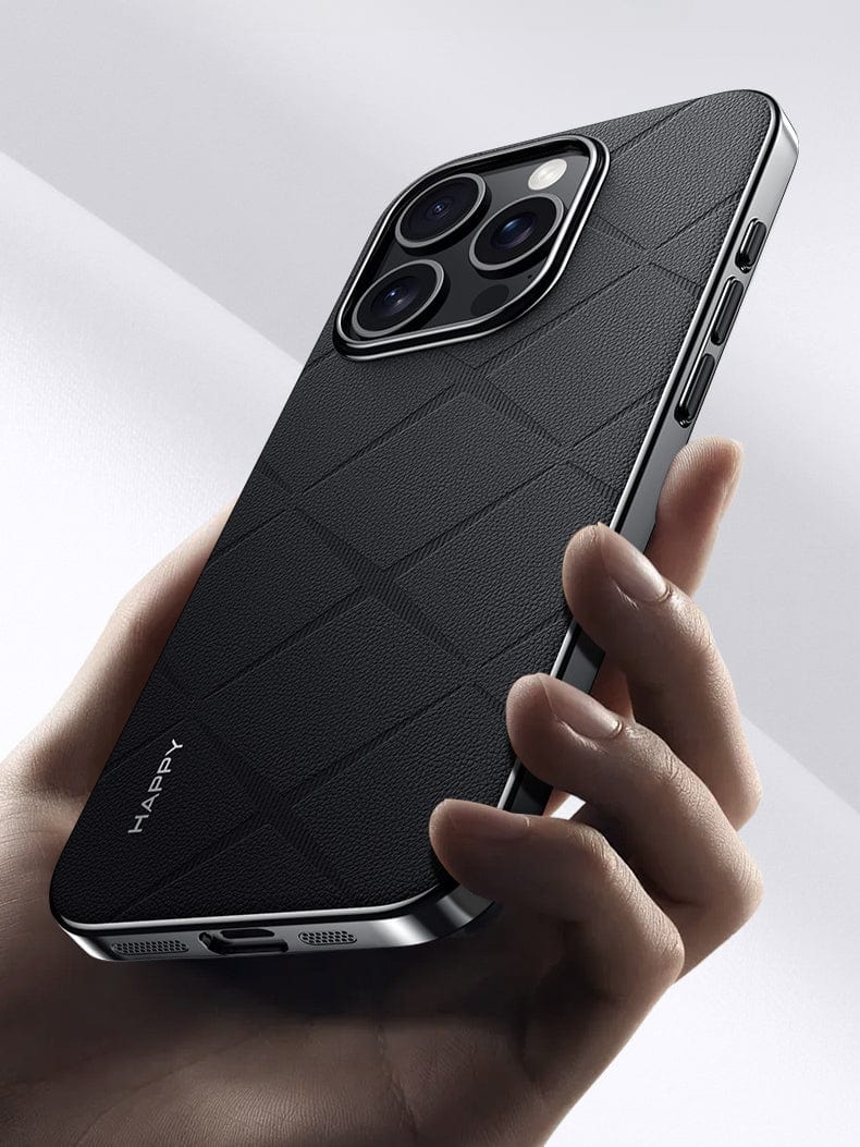 A hand holding a modern smartphone with the iPhone 16 Pro Max Premium Leather Case, featuring a black, shockproof design and a durable textured finish. The phone has three camera lenses on the back for superior protection and several buttons on the side with a metal finish. The brand name "HAPPY" is visible on the case.