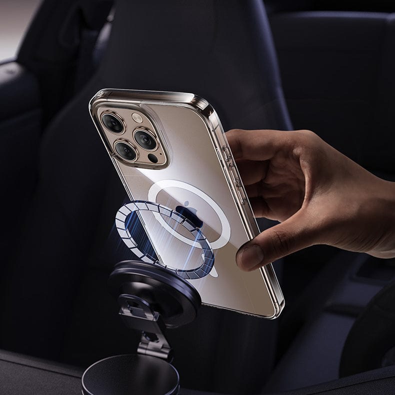 A hand places an iPhone 16 Pro Max, encased in a clear, anti-yellowing and anti-fingerprint case with magnetic adsorption, onto a magnetic car mount in a vehicle. The phone’s three rear cameras are prominently visible.