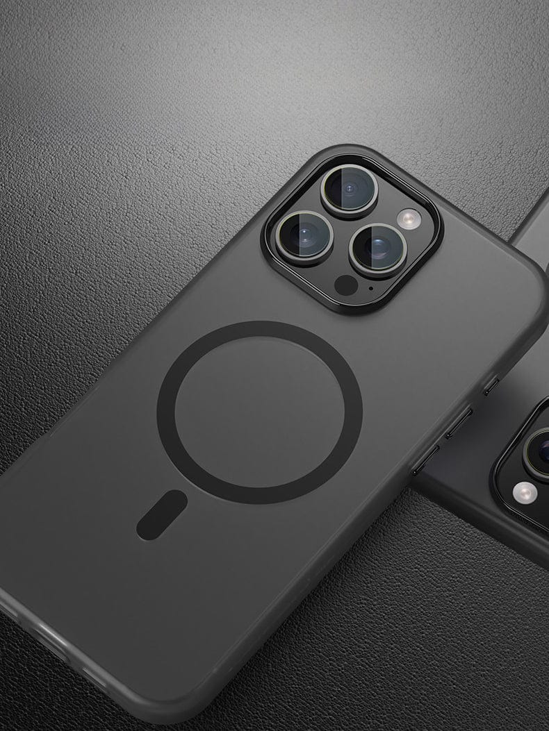 Close-up image of a black smartphone with a triple camera system and a circular design on its back cover, placed on a textured surface. The device boasts MagSafe compatibility with the iPhone 16 Pro Max Frosted Semi-Transparent MagSafe Case, offering anti-fingerprint features and shockproof protection.