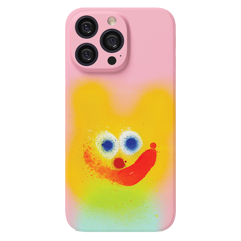 A *Colorful Spray Art iPhone 16 Pro Max Case Set - Playful Faces in Vibrant Graffiti Style* in pink, decorated with an abstract design featuring a yellow bear-like shape with blue eyes and a red mouth. The playful design gives the case a cheerful and whimsical appearance.