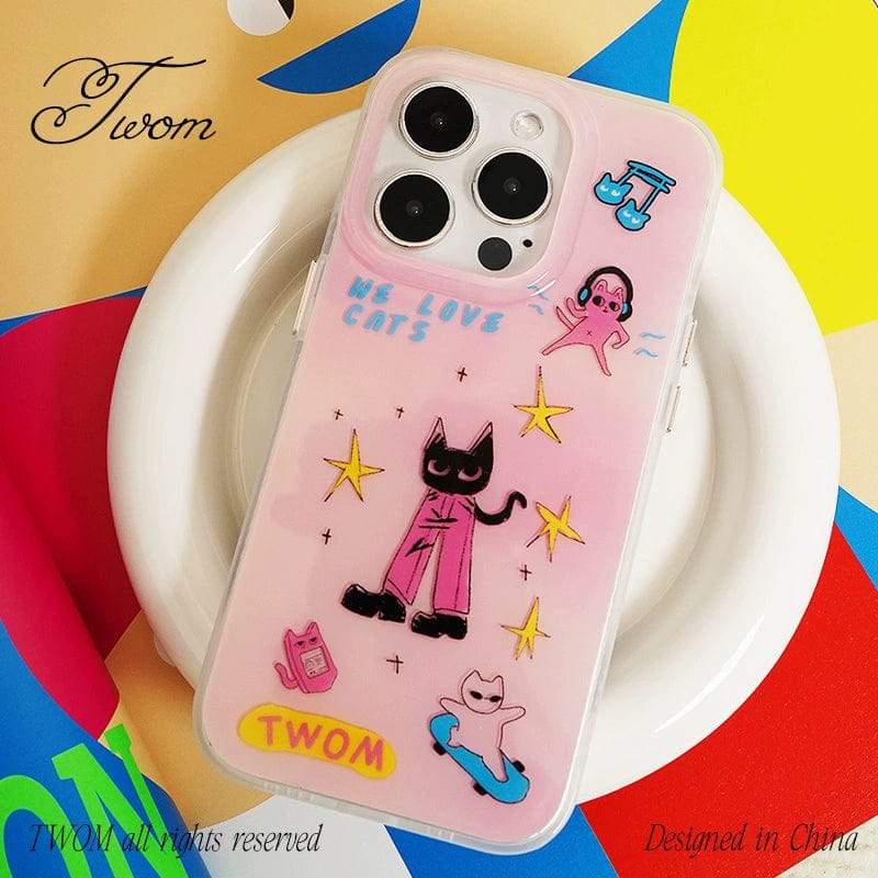 An iPhone 16 Pro Max with a We Love Cats iPhone 16 Pro Max Case sits on a white plate. The case, which is designed in cute pink with cartoon illustrations, features cats, stars, and playful shapes along with text reading "WE LOVE CATS" and "TWOM." The background is colorful with abstract patterns.