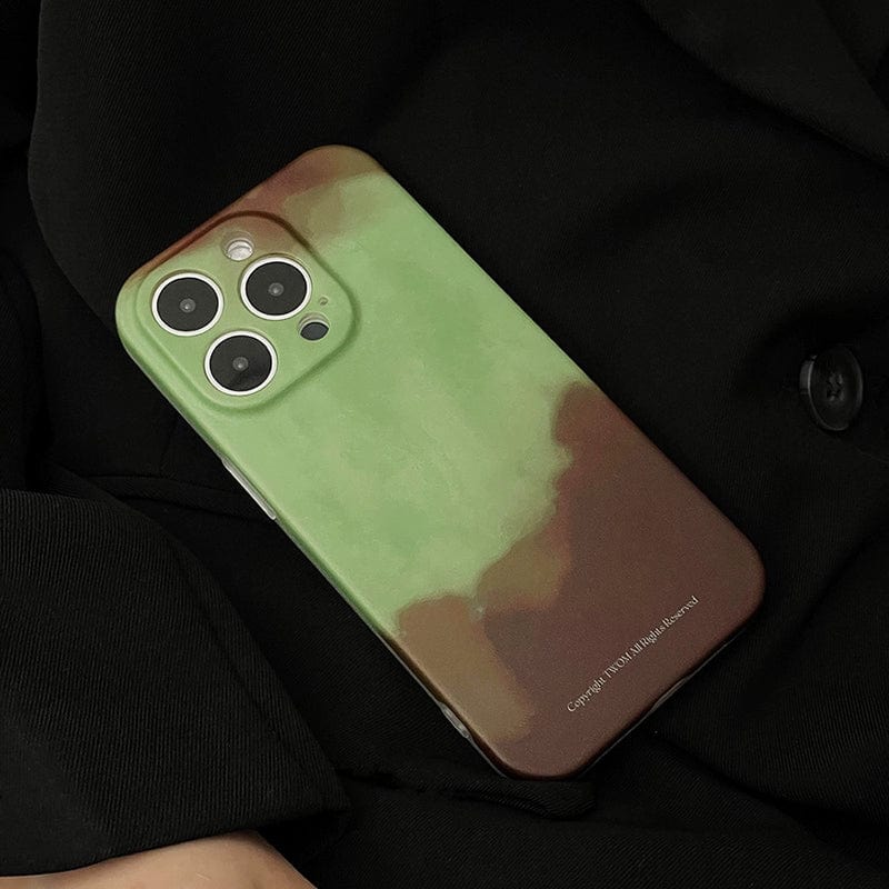 A Midnight Galaxy iPhone 16 Pro Max Case featuring a cosmic starry design with a green and brown gradient is placed against a black fabric background. The phone has a triple camera setup in the top left corner, and there is copyright text in white at the bottom right corner of the case.