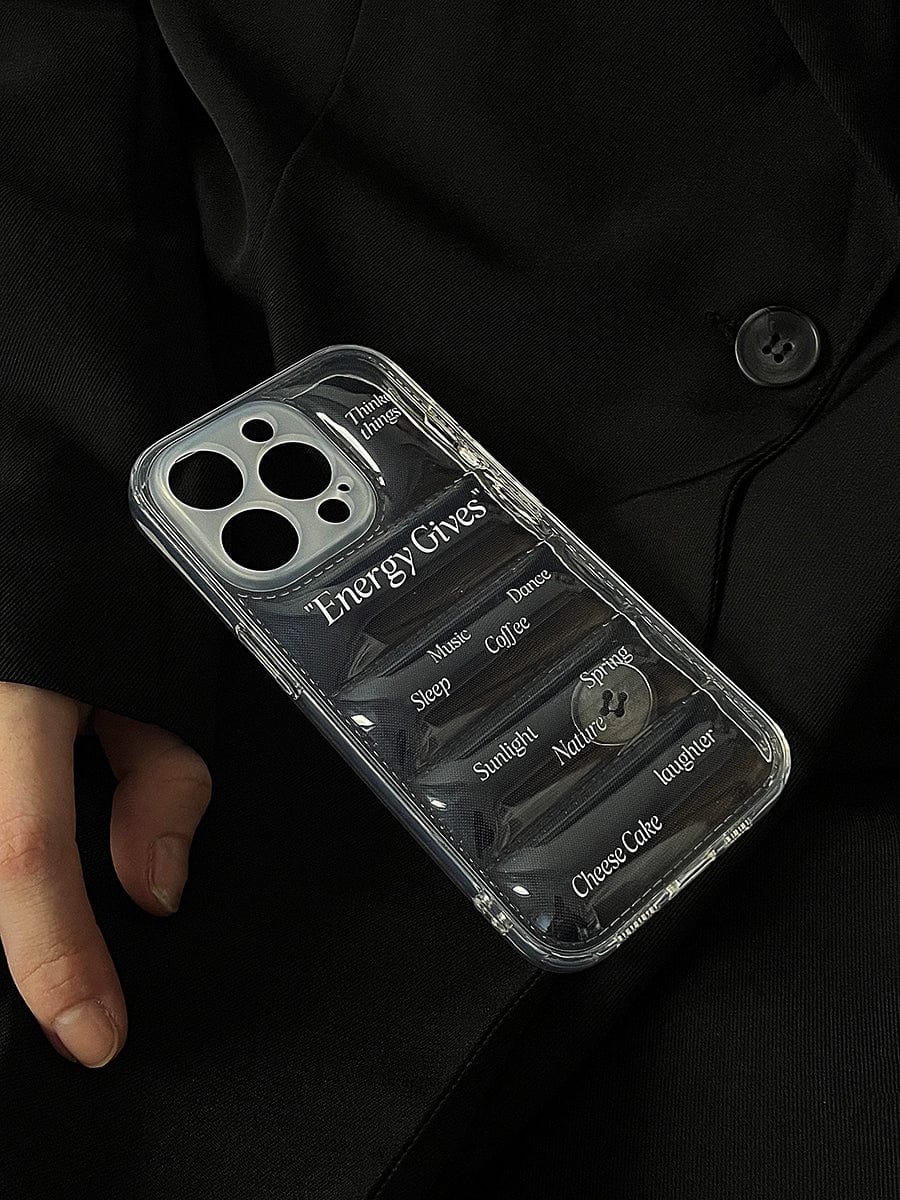 A person dressed in black holds an Energy Gives iPhone 16 Pro Max Case, featuring a transparent motivational design. The case lists sources of energy such as "Sunlight," "Nature," "Sleep," "Coffee," "Choose Cake," and "Regular" set against a dark background, and it has a textured all-inclusive protective cover.